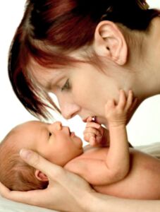 Newborn Hands on Moms Face
